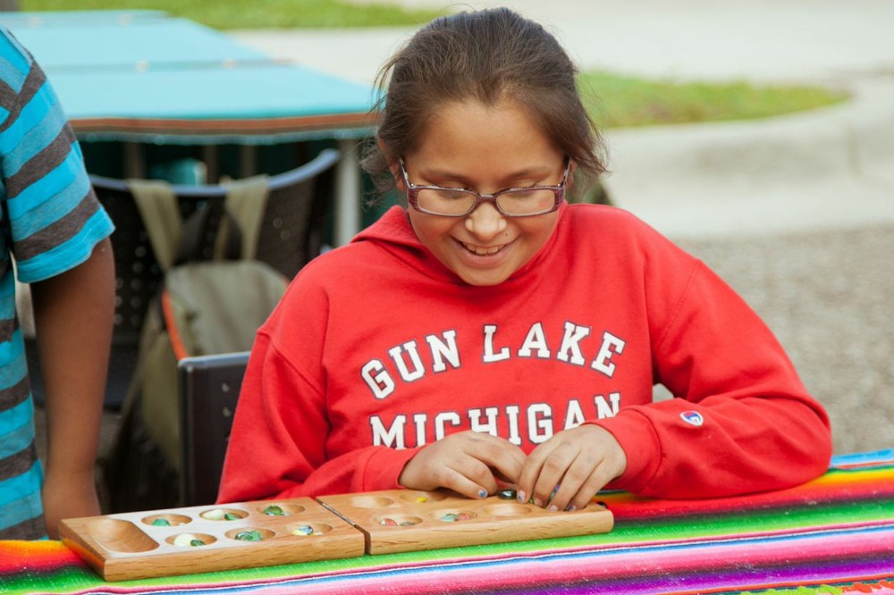 Girl playing mancala at the event